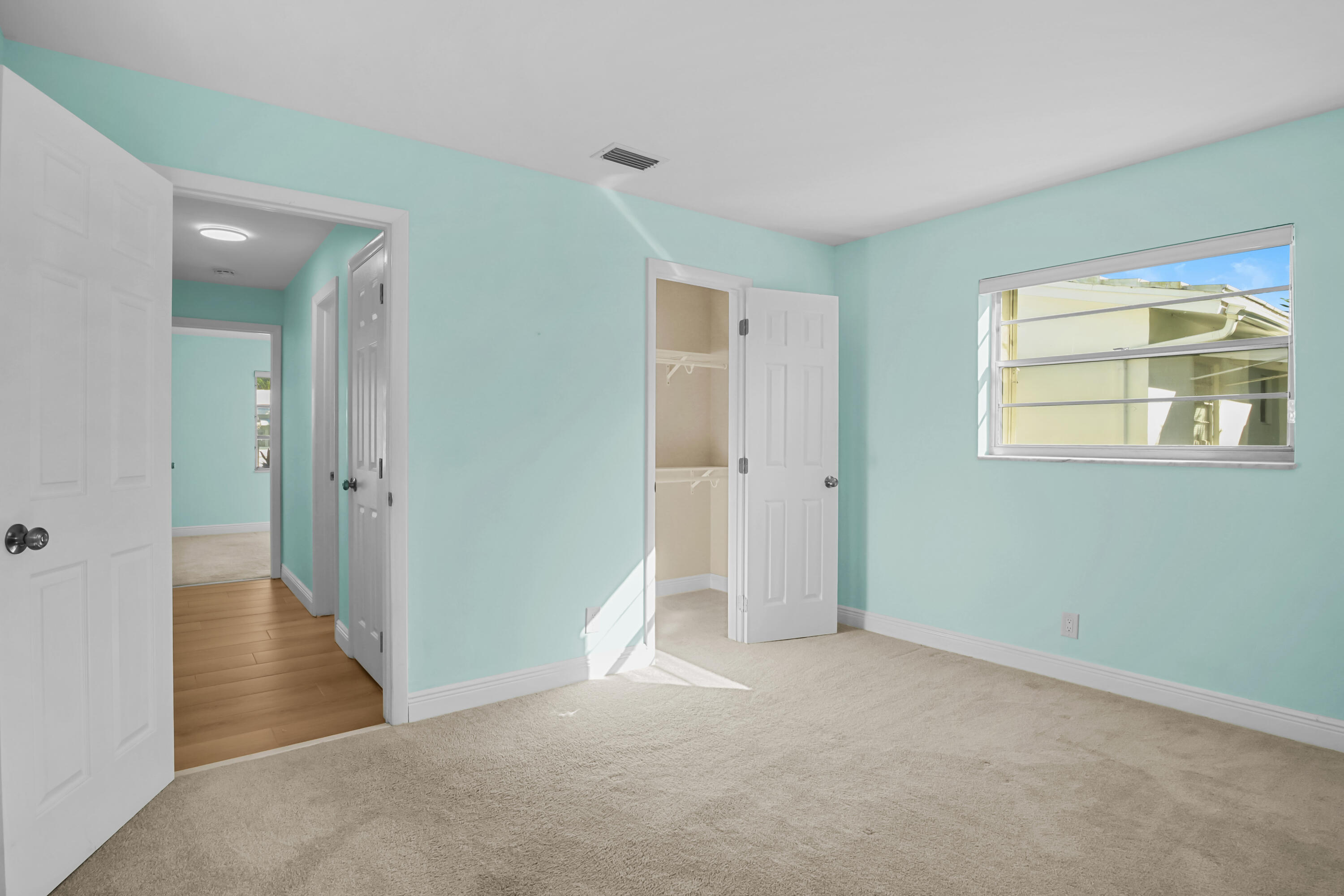 1308 Southwest 24th Street Boynton Beach, FL 33426 - Photo 17 of 19 an empty room with windows and closet