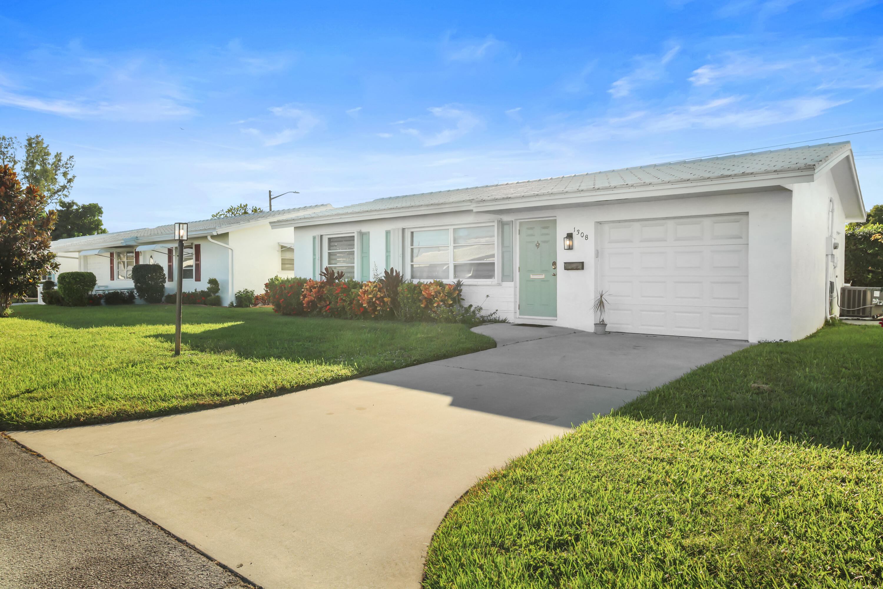 1308 Southwest 24th Street Boynton Beach, FL 33426 - Photo 2 of 19 a view of a house with a yard and plants