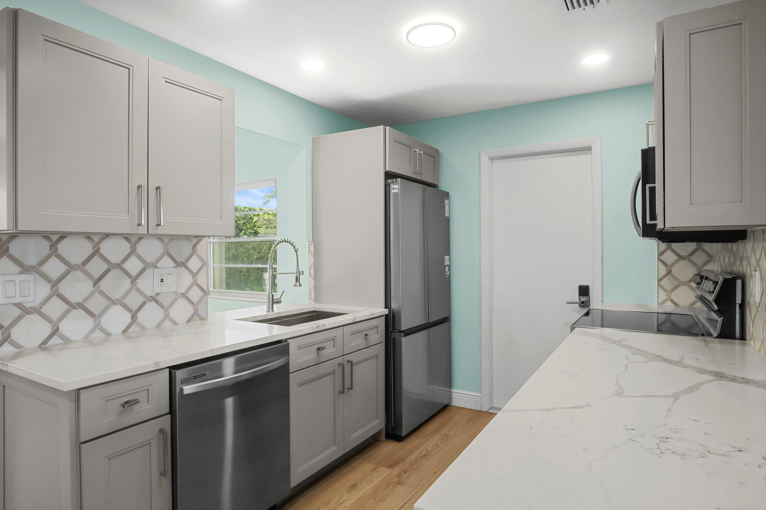 1308 Southwest 24th Street Boynton Beach, FL 33426 - Photo 5 of 19 a kitchen with a sink and refrigerator