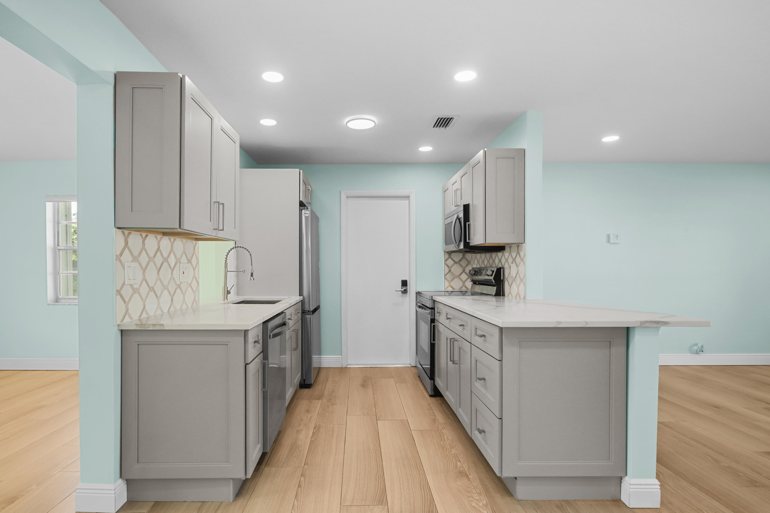 1308 Southwest 24th Street Boynton Beach, FL 33426 - Photo 7 of 19 a kitchen with granite countertop a sink and a stove top oven