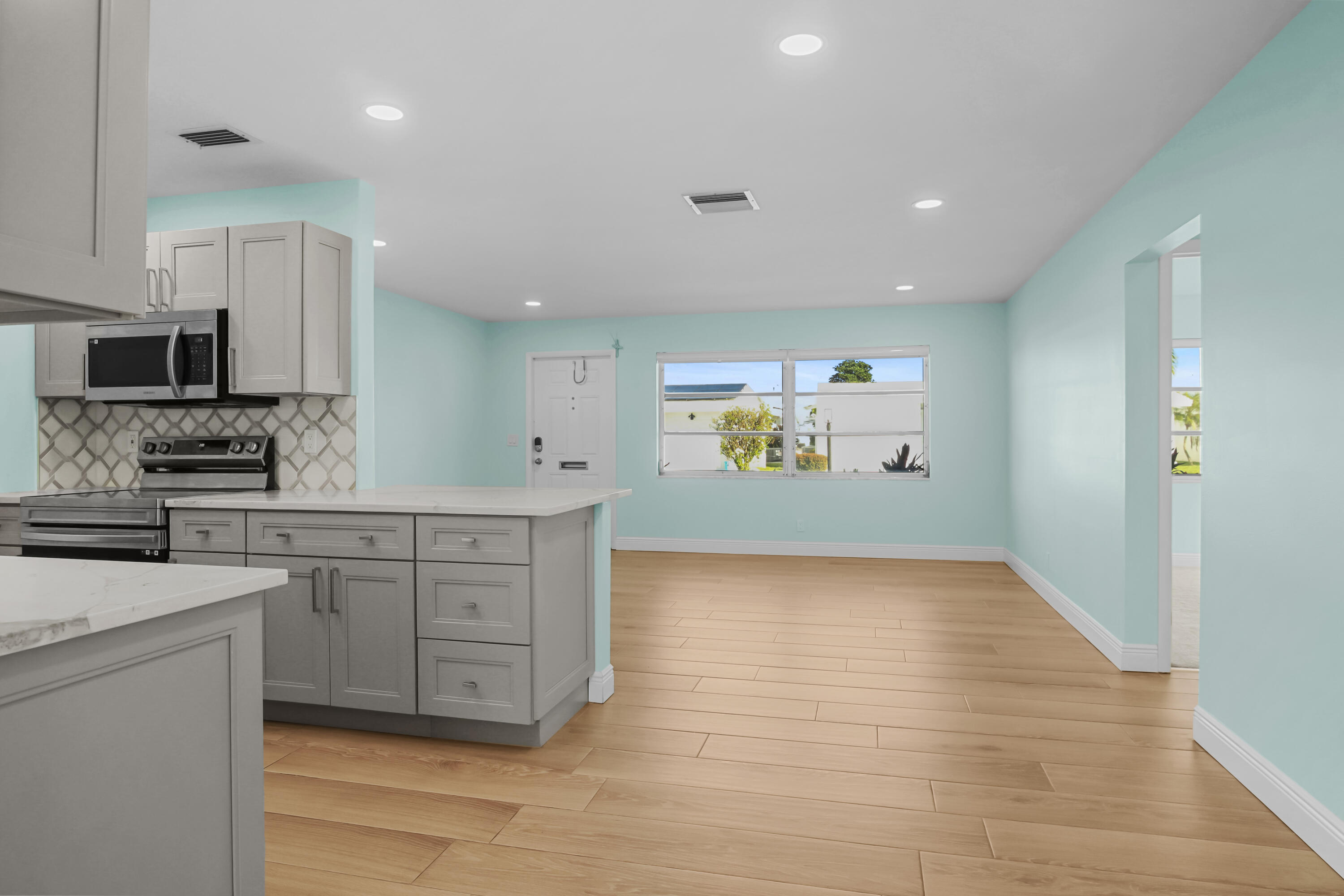 1308 Southwest 24th Street Boynton Beach, FL 33426 - Photo 9 of 19 a kitchen with stainless steel appliances granite countertop a stove a sink and a refrigerator