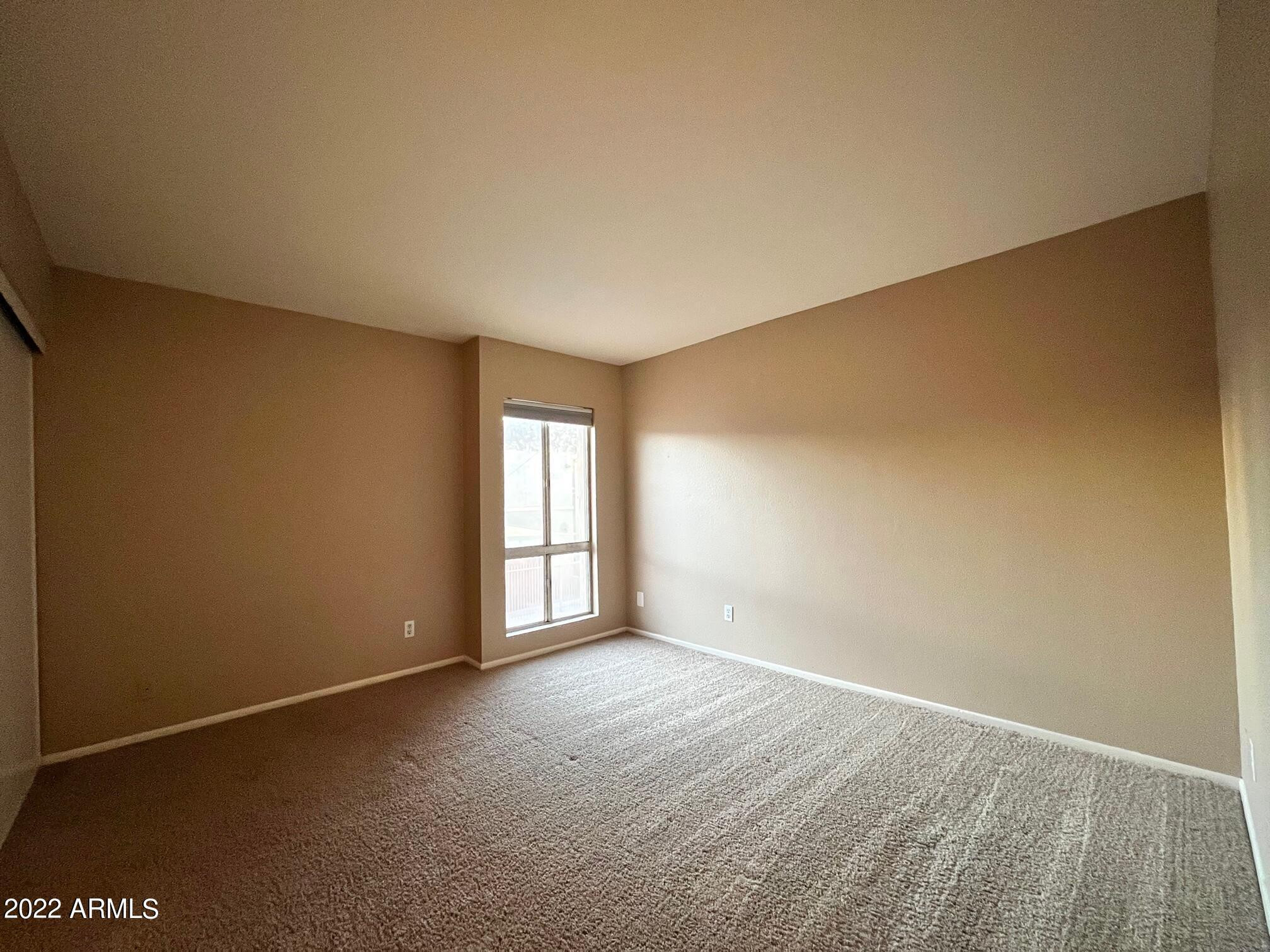 1701 West Tuckey Lane, Unit 225 Phoenix, AZ 85015 - Photo 6 of 13 an empty room with windows