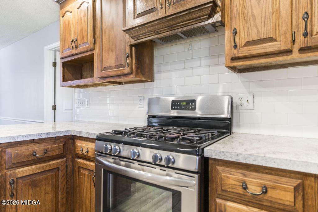 3710 Sandy Circle Macon, GA 31216 - Photo 15 of 44 a kitchen with stainless steel appliances granite countertop a stove and a microwave