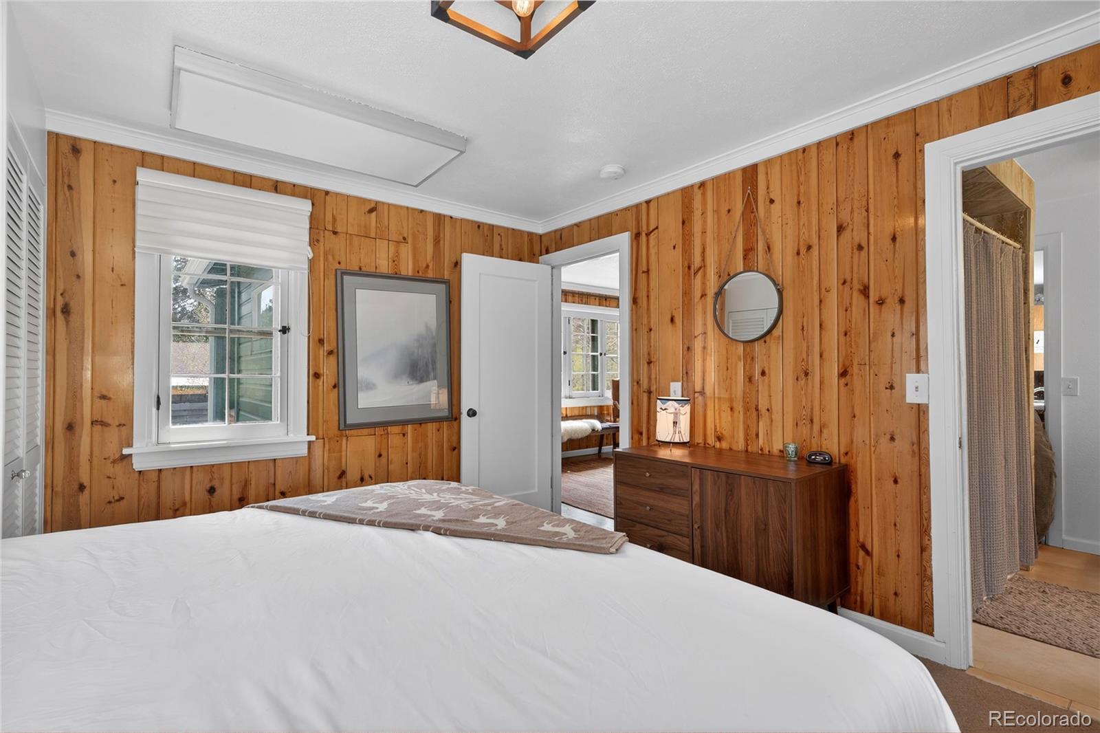 327 Vasquez Road, Unit E1 Winter Park, CO 80482 - Photo 24 of 43 a bedroom with a bed dresser and a window