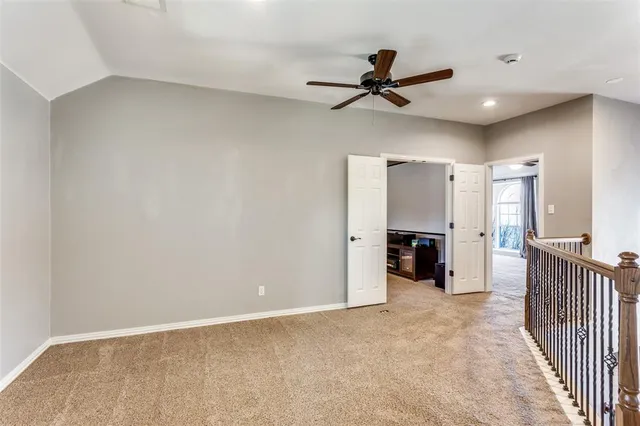 a view of a livingroom with a ceiling fan and entryway