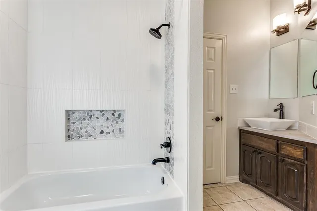 a bathroom with a bathtub and a sink