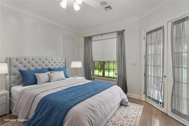 a bedroom with a large bed and a chandelier