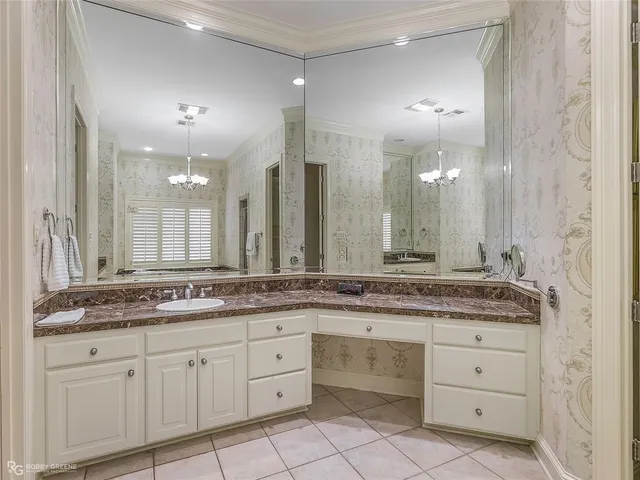 a bathroom with a granite countertop sink double and mirror