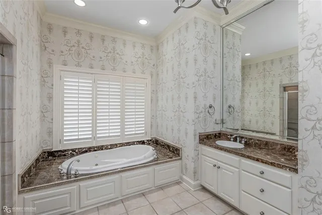 a bathroom with a granite countertop tub sink and mirror