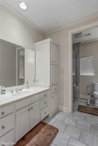 a spacious bathroom with a double vanity sink and a mirror
