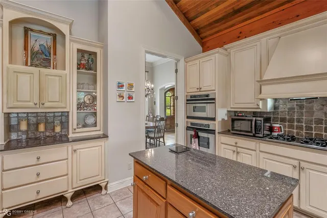 a kitchen with stainless steel appliances granite countertop a stove and cabinets