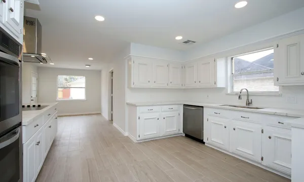 a large kitchen with a lot of counter space and appliances