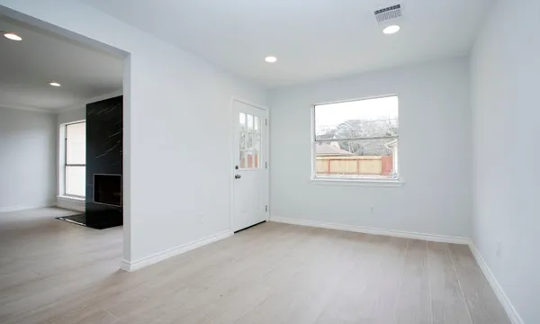 an empty room with windows and closet