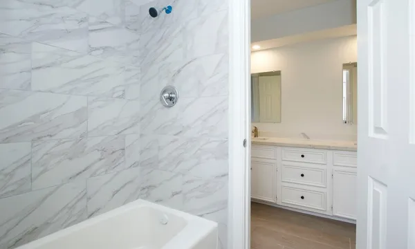 a bathroom with a bathtub and a sink