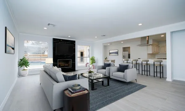 a living room with furniture wooden floor and a flat screen tv