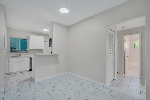 a kitchen with a sink and refrigerator