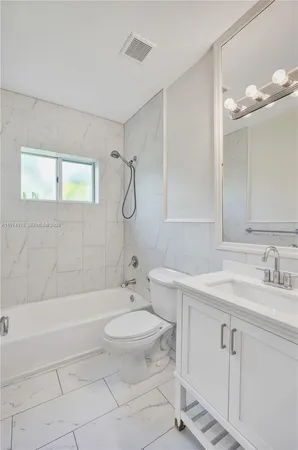 a bathroom with a sink toilet vanity and shower