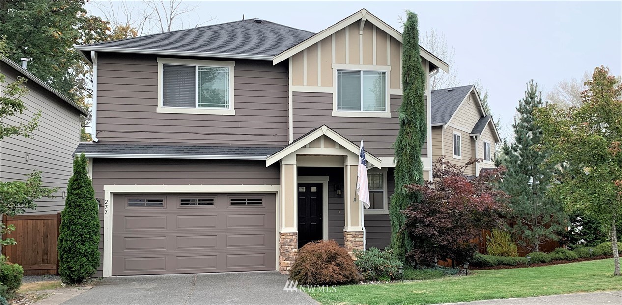273 Graham Avenue Northeast Renton, WA 98059 - Photo 1 of 23 a front view of a house with a garden