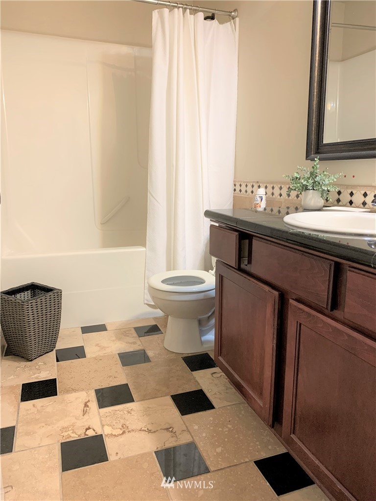 273 Graham Avenue Northeast Renton, WA 98059 - Photo 15 of 23 a bathroom with a sink toilet and a mirror