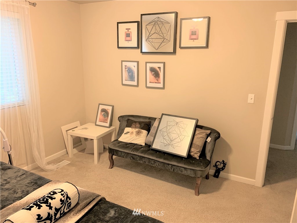 273 Graham Avenue Northeast Renton, WA 98059 - Photo 17 of 23 a living room with a bed furniture and mirror
