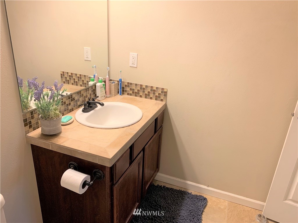 273 Graham Avenue Northeast Renton, WA 98059 - Photo 20 of 23 a bathroom with a sink and a mirror
