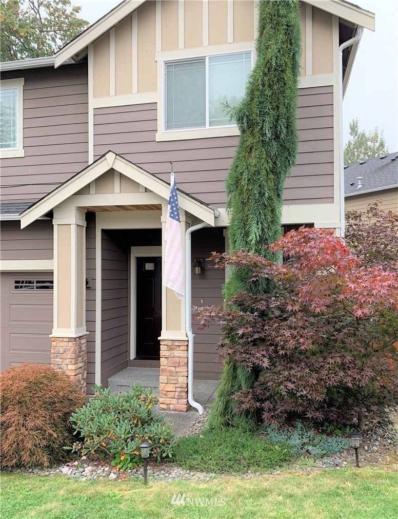 273 Graham Avenue Northeast Renton, WA 98059 - Photo 3 of 23 a front view of a house with garden