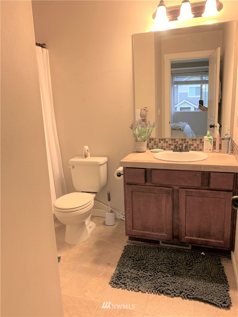 273 Graham Avenue Northeast Renton, WA 98059 - Photo 21 of 23 a bathroom with a sink a toilet and mirror