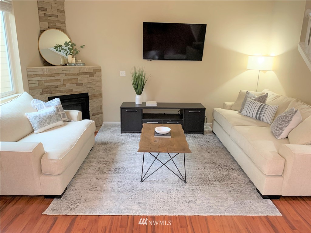 273 Graham Avenue Northeast Renton, WA 98059 - Photo 6 of 23 a living room with furniture a flat screen tv and a fireplace