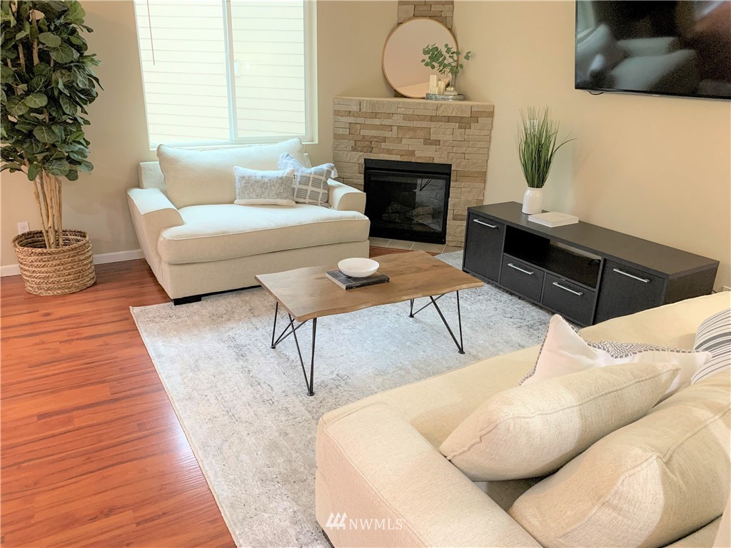 273 Graham Avenue Northeast Renton, WA 98059 - Photo 7 of 23 a living room with furniture and a fireplace