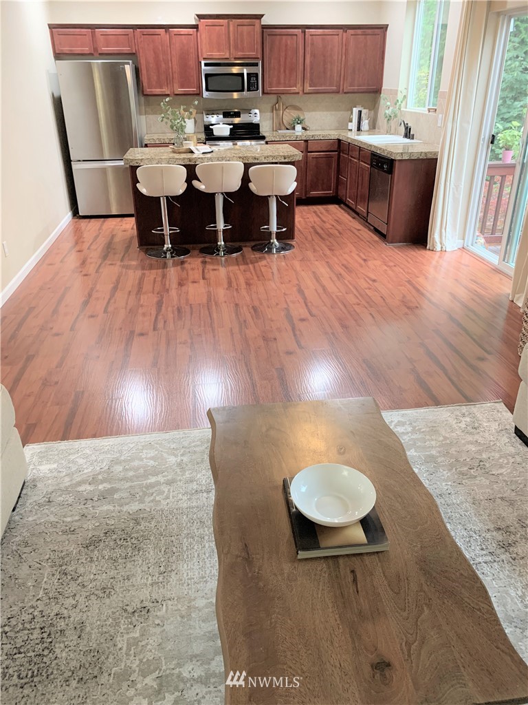 273 Graham Avenue Northeast Renton, WA 98059 - Photo 8 of 23 a view of a dining room with furniture and wooden floor