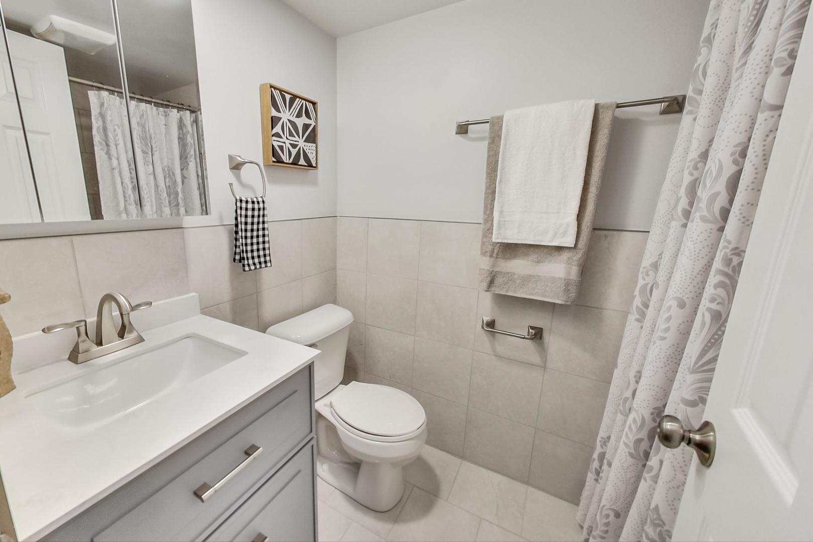 1422 West Lexington Street, Unit 2F Chicago, IL 60607 - Photo 12 of 19 a bathroom with a sink toilet and shower