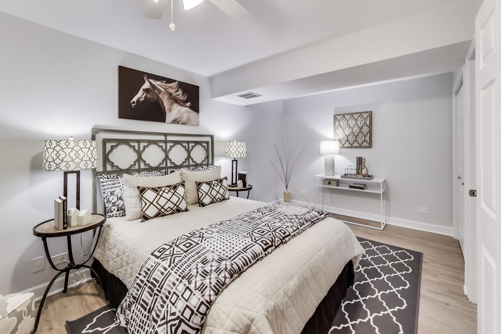 1422 West Lexington Street, Unit 2F Chicago, IL 60607 - Photo 13 of 19 a bedroom with a bed and a lamp on table