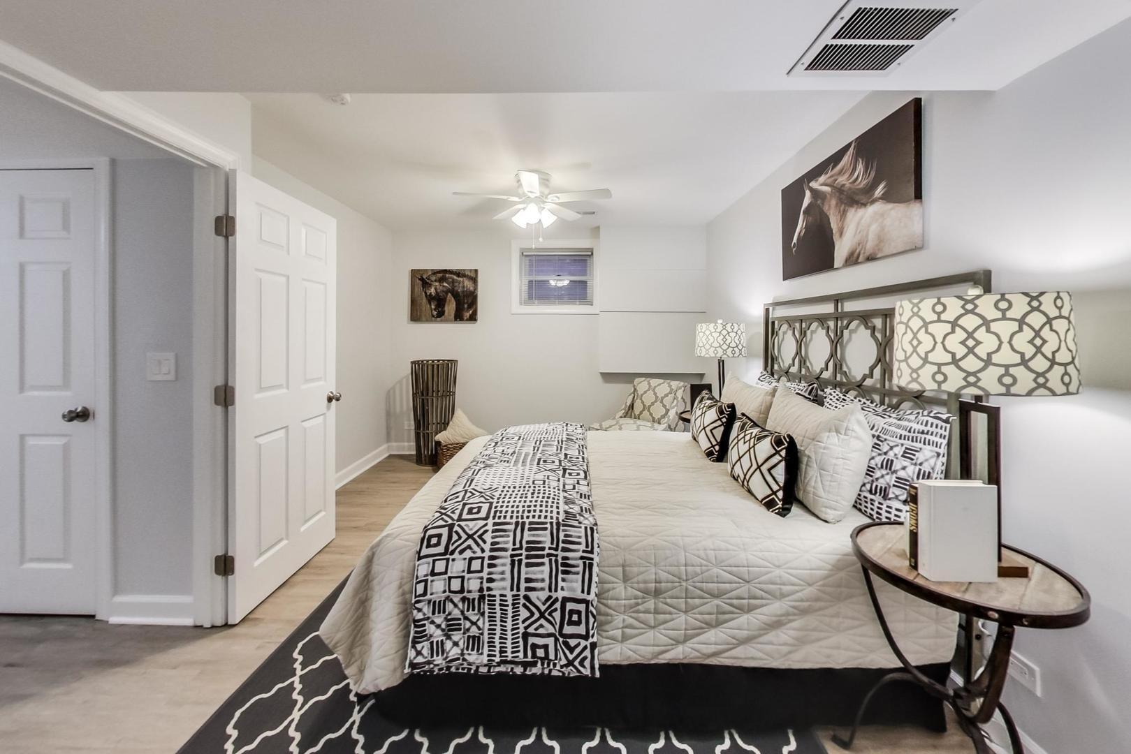 1422 West Lexington Street, Unit 2F Chicago, IL 60607 - Photo 14 of 19 a bedroom with a bed and dresser with mirror