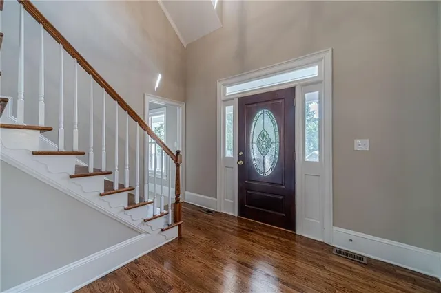 a view of a hallway view with wooden floor and staircase