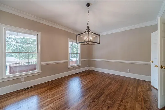 a view of wooden floor and windows in a room