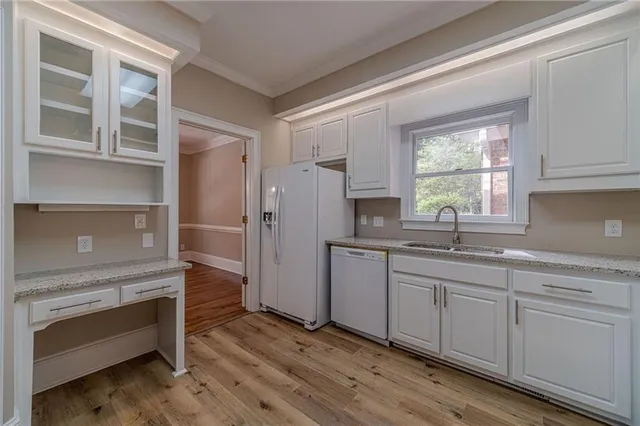a kitchen with a refrigerator and a sink