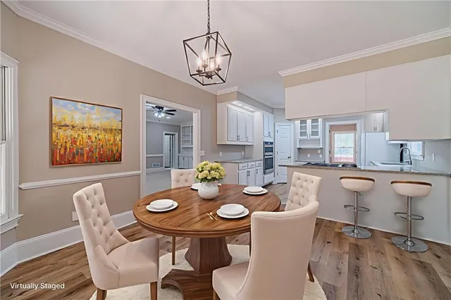 a view of a dining room with furniture and chandelier