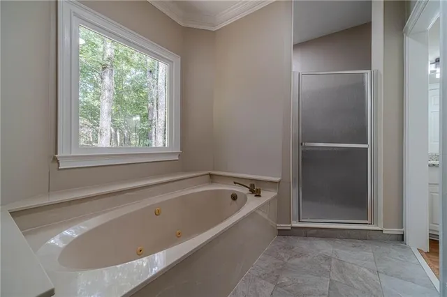 a bathroom with a granite countertop sink a mirror and a shower