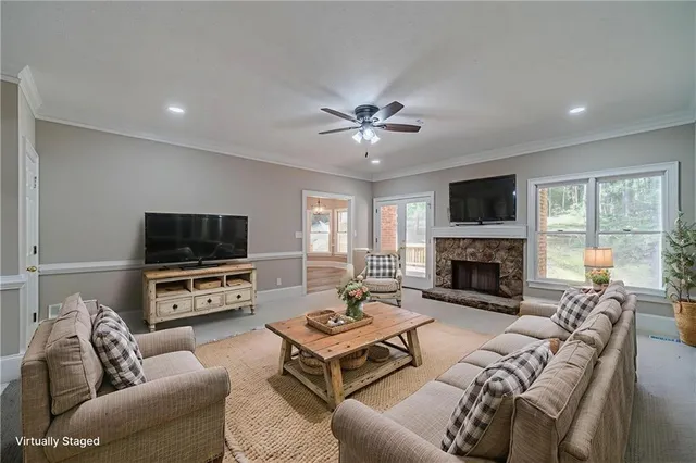 a living room with furniture a fireplace and a flat screen tv