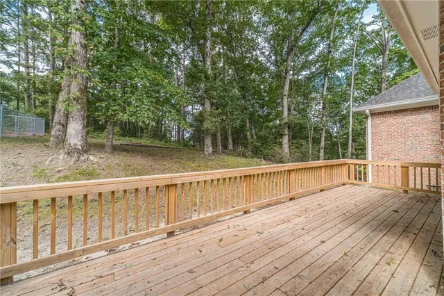 a view of a house with a yard and large tree
