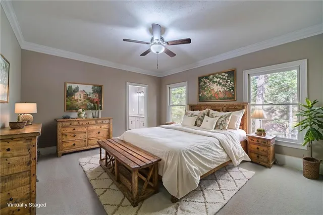a bedroom with a bed and ceiling fan