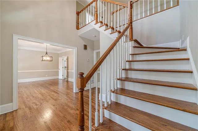 a view of entryway and hall with wooden floor