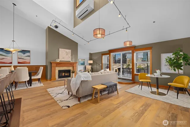 a living room with furniture a fireplace and a potted plant