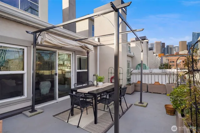 a view of a patio with a table and chairs and potted plants