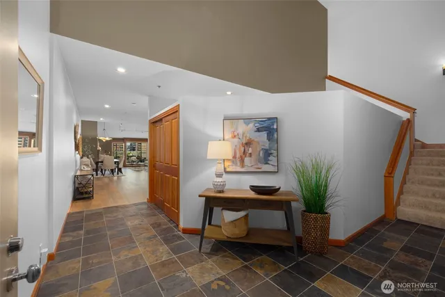 a hallway with furniture and a potted plant