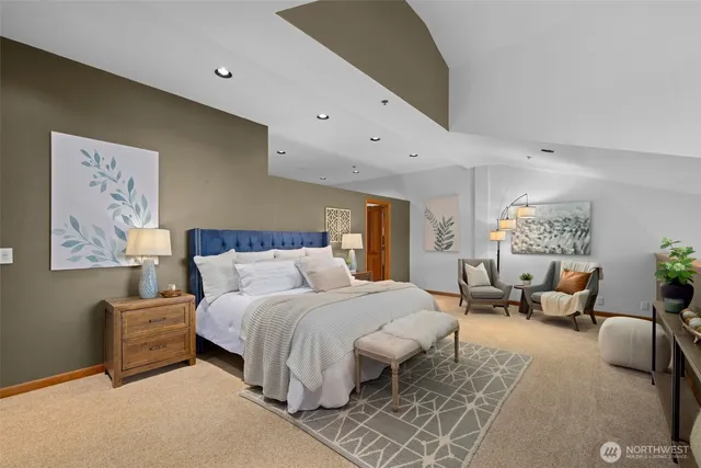 a bedroom with a large bed couch and a window