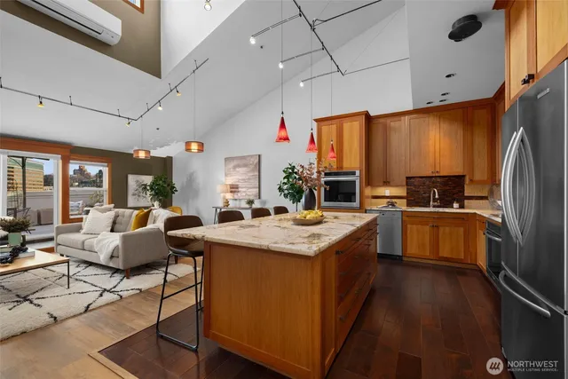 a kitchen with stainless steel appliances granite countertop a stove and a refrigerator
