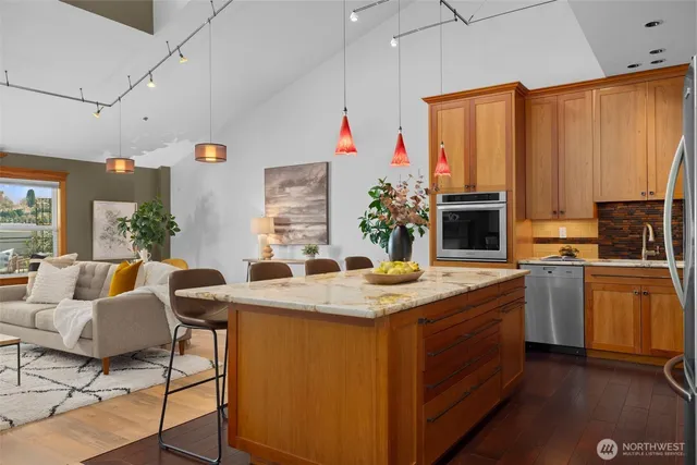 a room with kitchen island granite countertop furniture and a fireplace