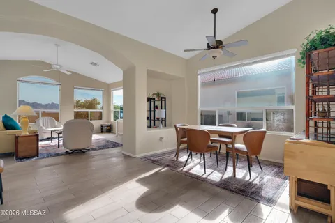 a dining room with furniture window and wooden floor