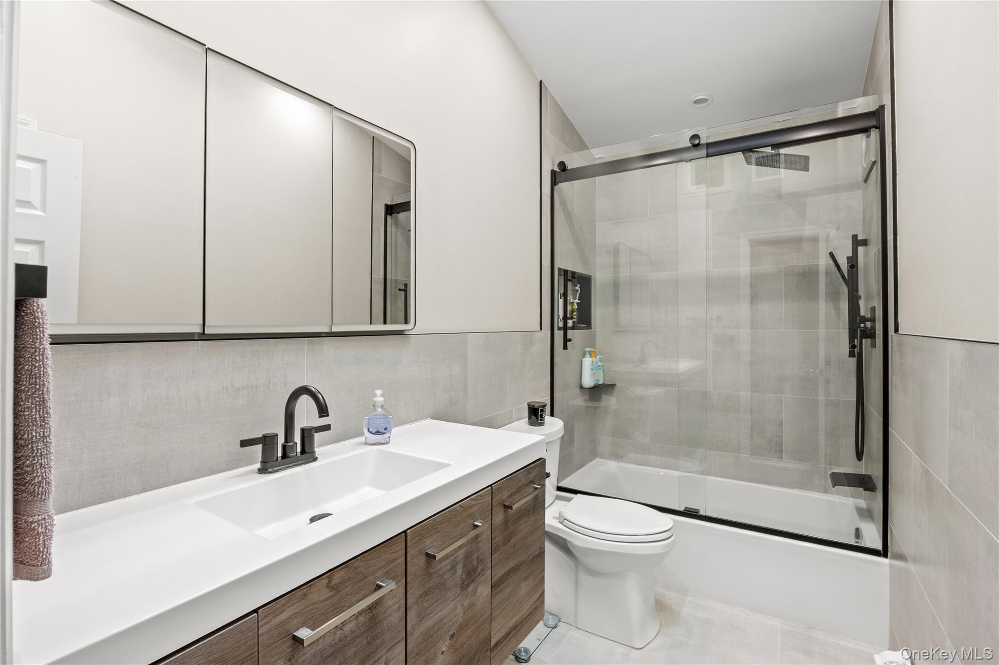 31 Halliday Road Coram, NY 11727 - Photo 12 of 30 a bathroom with a shower sink vanity mirror and toilet